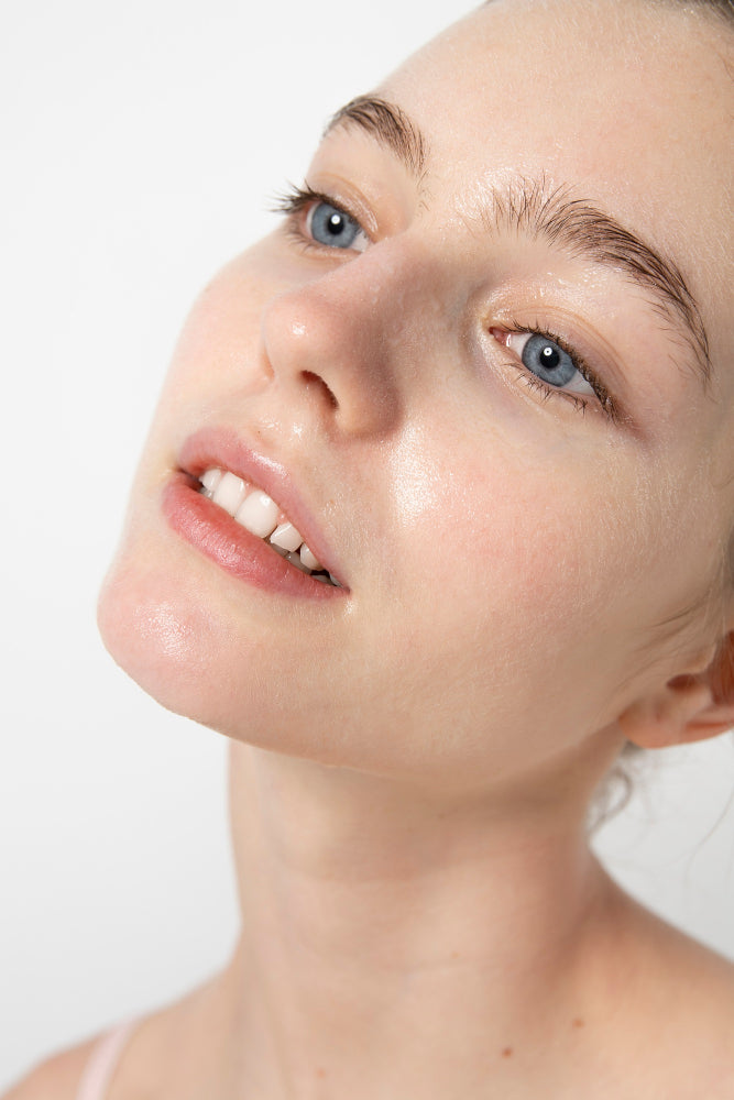 woman after use of jojoba oil on her face for cleansing purposes